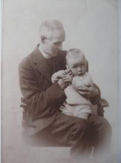 Rev. Bentley with Keith Parker on his knee